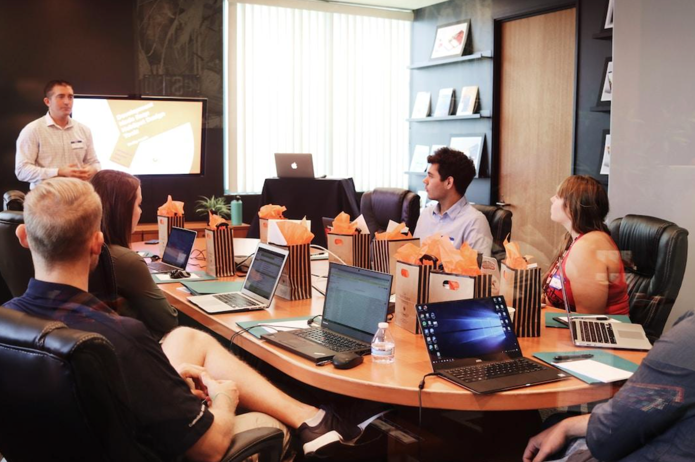 A small team in an office discussing PSA software during a meeting